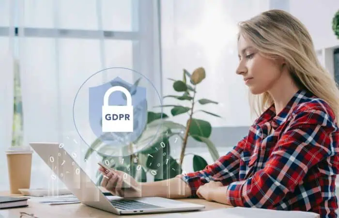side view of businesswoman using smartphone at workplace in office, gdpr cyber security concept