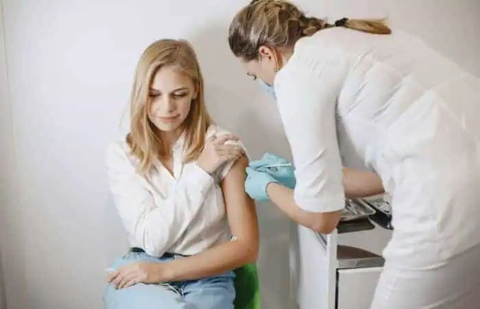 Woman doctor gives a vaccine to patients